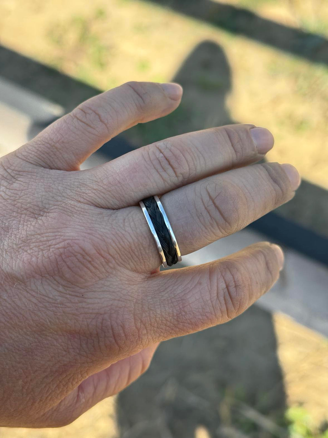 Model wearing Artisan custom horse hair memorial ring in sterling silver