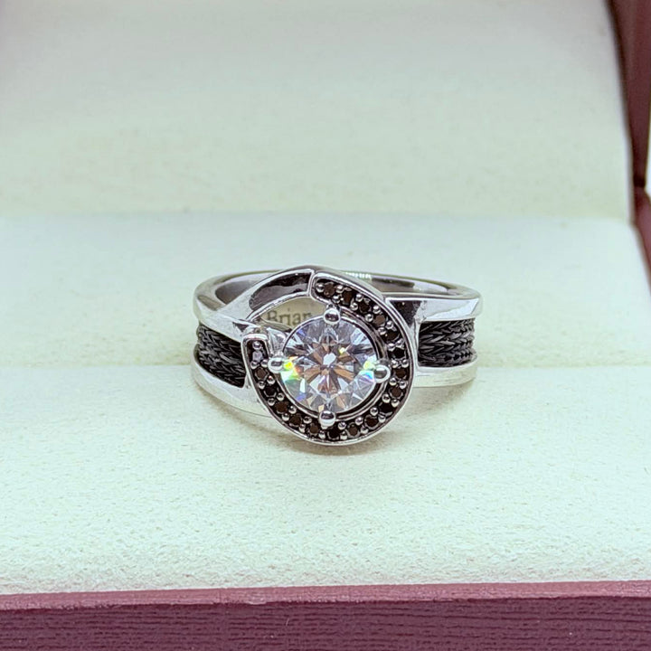 horseshoe ring with woven horsehair black diamonds and large center diamond on cream background