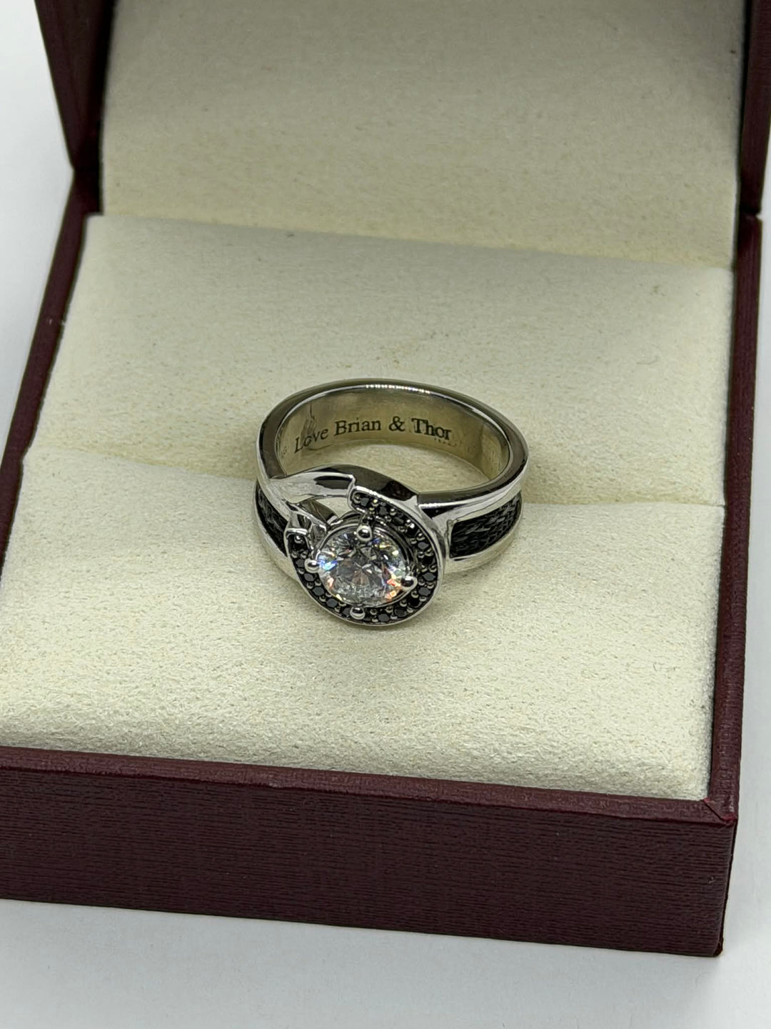 horseshoe ring with woven horsehair black diamonds and large center diamond on cream background showing engraving inside ring