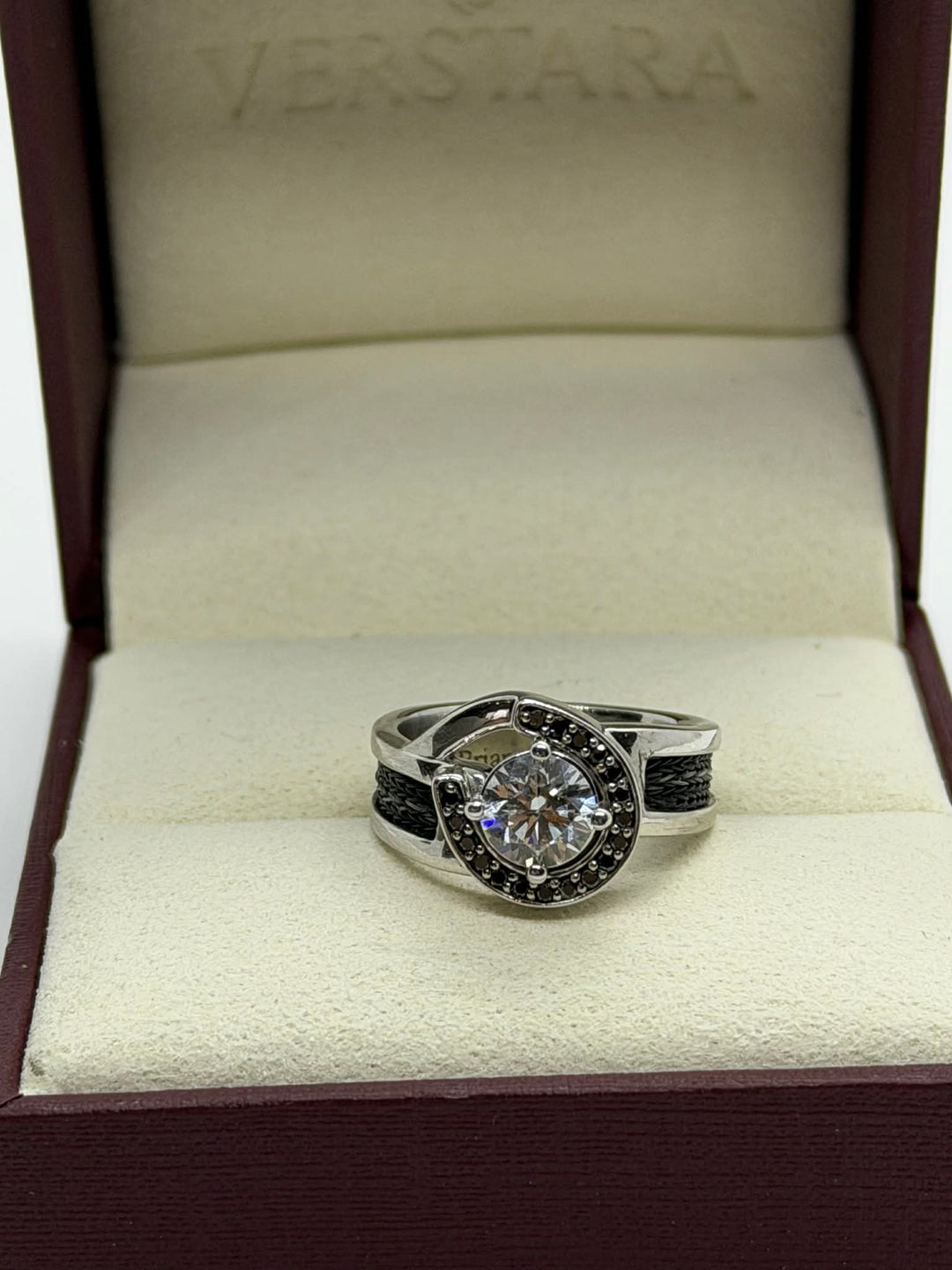 horseshoe ring with woven horsehair black diamonds and large center diamond on cream background