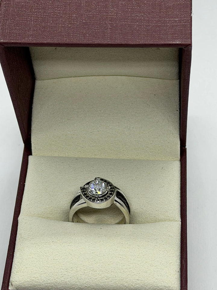 side view of horseshoe ring with woven horsehair black diamonds and large center diamond on cream background