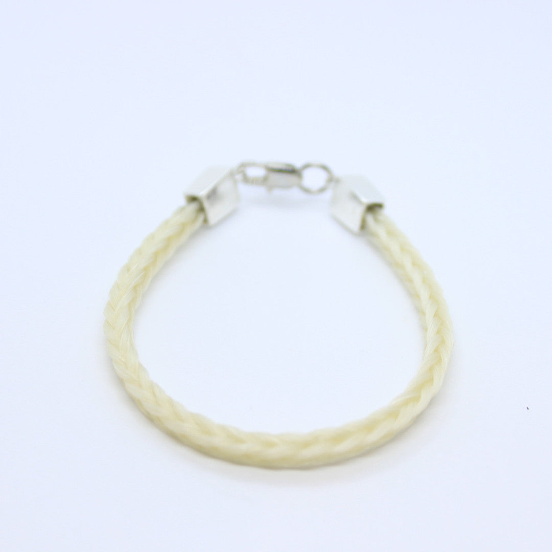 White braided horsehair  bracelet with platinum ends on a bright white background