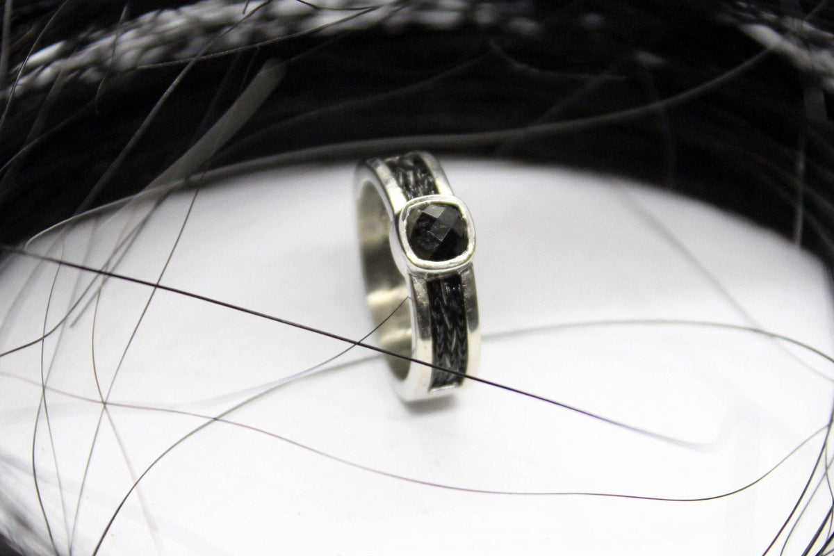 Horsehair ring with woven horsehair set into a sterling silver band with a black onyx gemstone